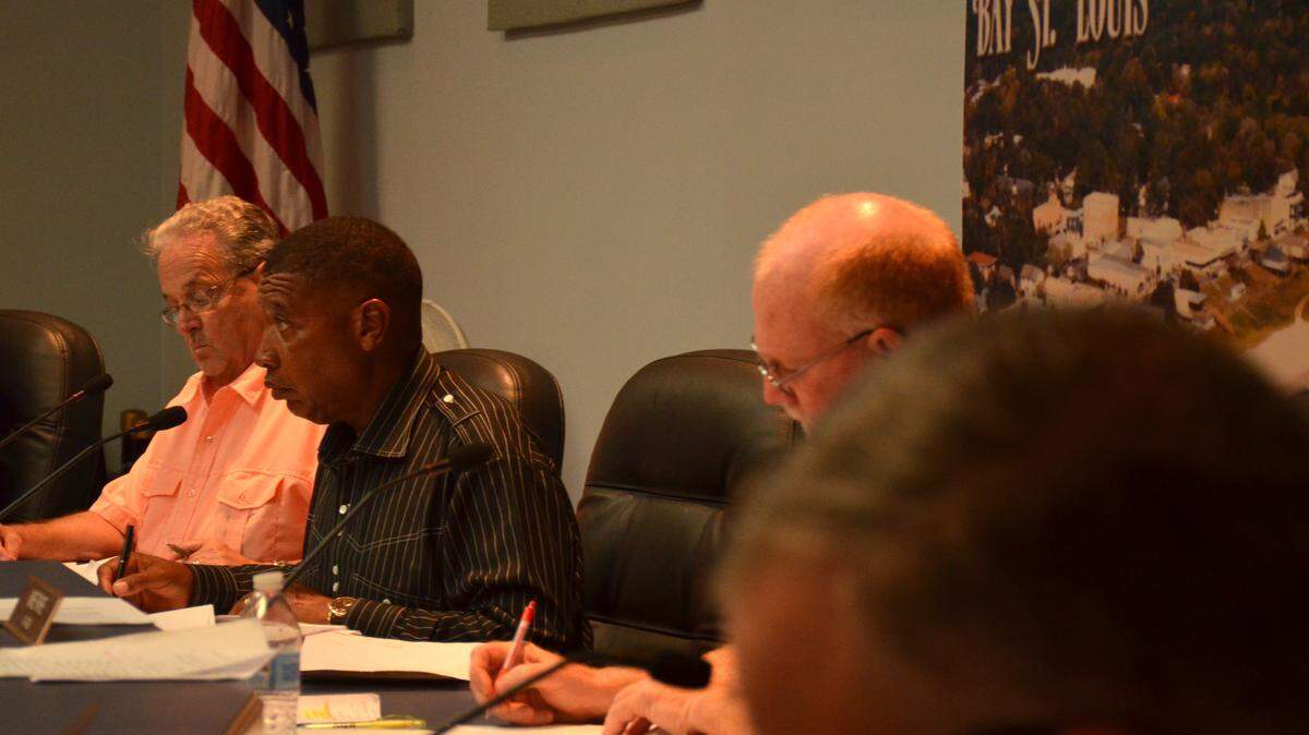 JUSTIN MITCHELL/SUN HERALD/FILE 
 Ward 3 Councilman Jeffery Reed, center, reviews Bay St. Louis' proposed budget worksheet at a council meeting in 2014. The council has received the Department of Justice's preliminary findings regarding the Bay St. Louis Police Department's federal equitable sharing fund.