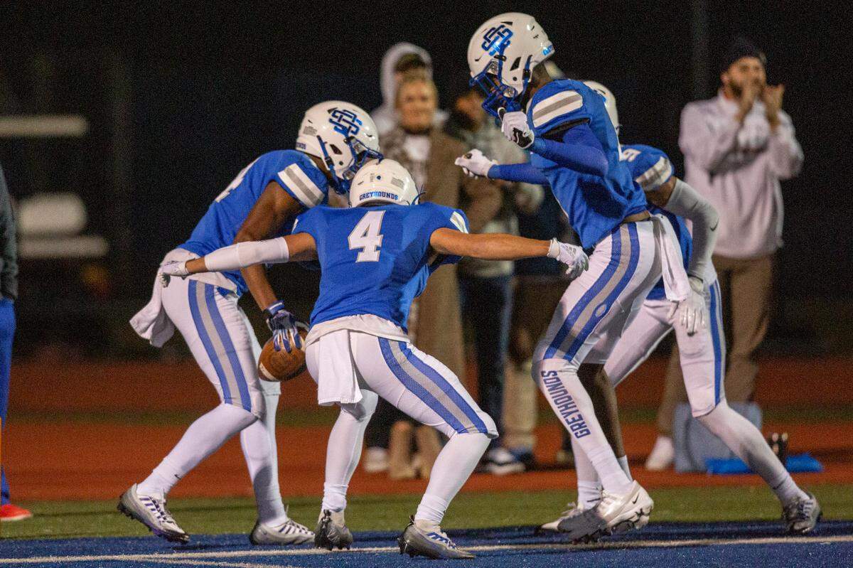 Ocean Springs players celebrate in the end zone after scoring against Oak Grove during a 6A playoff game at Greyhound Stadium in Ocean Springs on Friday, Nov. 18, 2022.