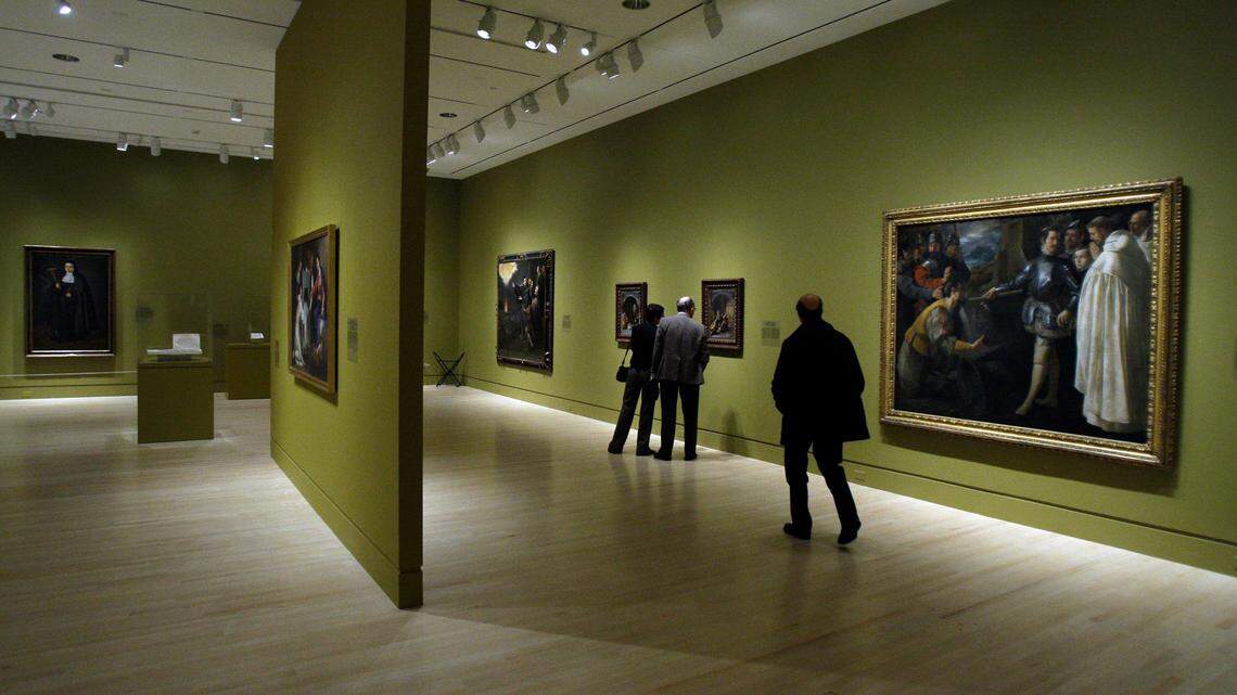 Visitors looks at the paintings on display in the exhibit “Sacred Spain” at the Indianapolis Museum of Art in Indianapolis, Tuesday, Nov. 17, 2009. Museum President Charles Venable resigned after outcry over a job post seeking to hire a director who would help maintain the museum’s “core, white audience.” (AP Photo/Darron Cummings)
