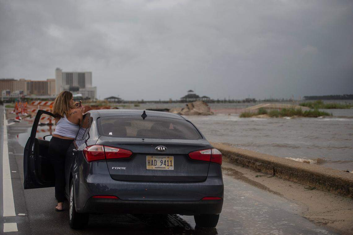 A storm watcher photographs the incoming hurricane on Highway 90 in Biloxi on Sunday.