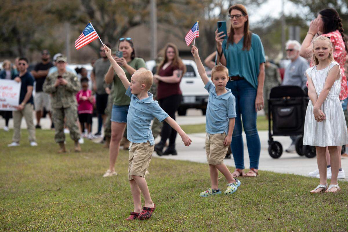 Families await the arrival of members of Naval Mobile Construction Battalion 1 as they return home from deployment on Thursday, March 13, 2025, to Naval Construction Battalion Center Gulfport.