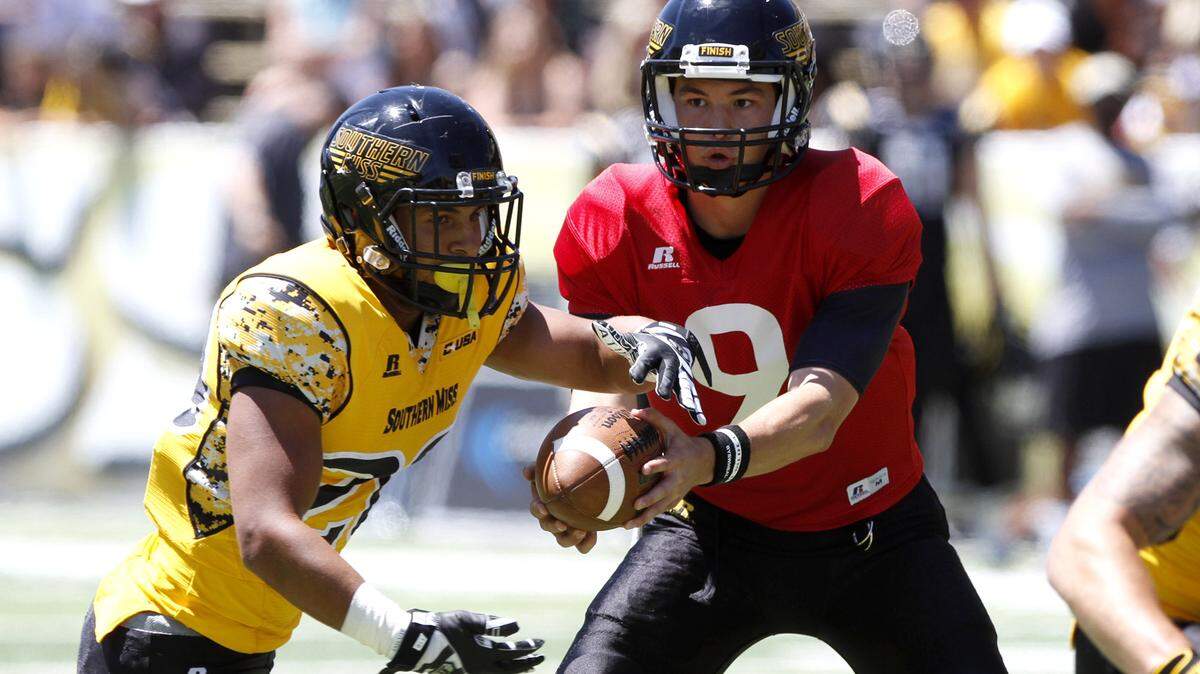 TIM ISBELL/SUN HERALDNick Mullens hands off to Patrick Brooks during Black and Gold game, Saturday, Apr. 23, 2016. 
