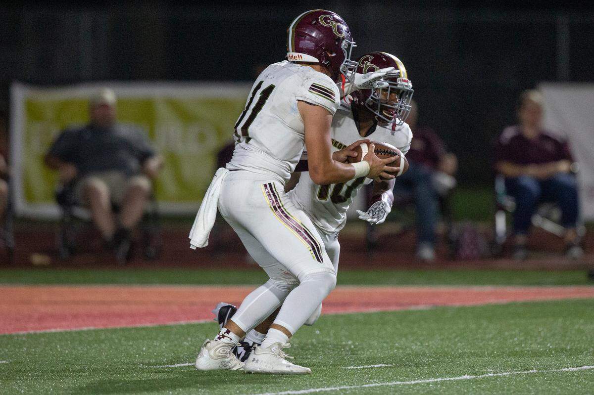 George County quarterback Gage Reeves hands the ball off to Brandon Gautier during their game against Biloxi at Biloxi High School on Friday, Sept. 8, 2023.