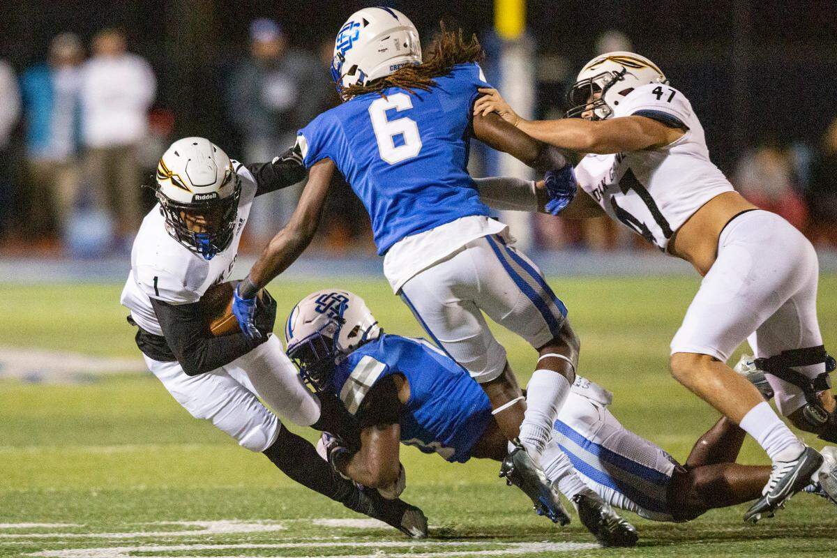 Oak Grove’s Jaquerrius Gray gets tackled by Ocean Springs during a 6A playoff game at Greyhound Stadium in Ocean Springs on Friday, Nov. 18, 2022.