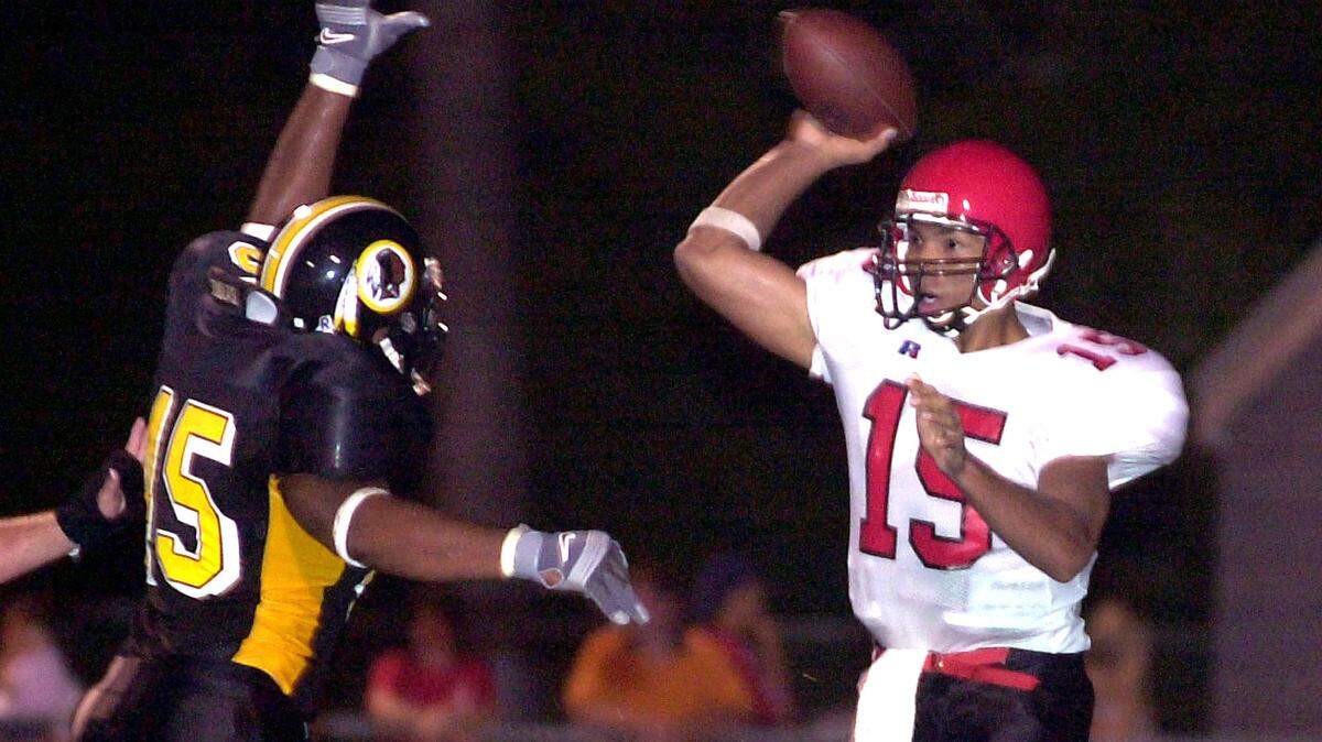SUN HERALD FILE/2001 
 D'Iberville Kris Arnold (45) tries to block the pass of Harrison Central quarterback (15) Jeremy Lee as he passes to a receiver in the first half of play at D'Iberville. Lee died last week of a heart attack. His funeral is Saturday.