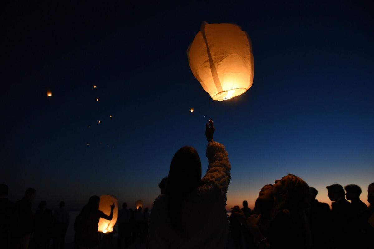 Dozens gathered to release lanterns in Henderson Point after funeral services for Pass Christian teen Abby Bosarge, who died from leukemia.