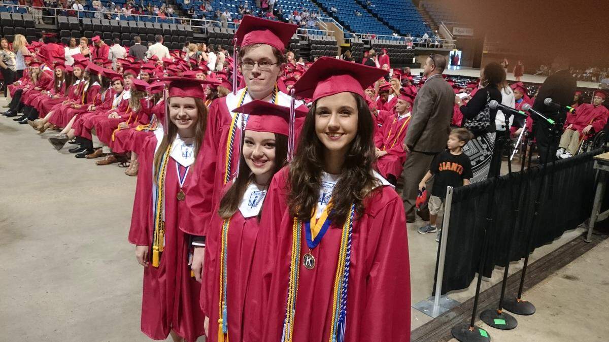 GORDON JACKSON/SPECIAL TO THE SUN HERALD 
 Valedictorian Abbigail Mattfeld, front, is flanked by salutatorian Kassidy Reynolds and top honor students John Meynardie and Margaret Lee during Biloxi High School's 2016 graduation ceremony Tuesday, May 24, 2016, at the Coast Coliseum.
