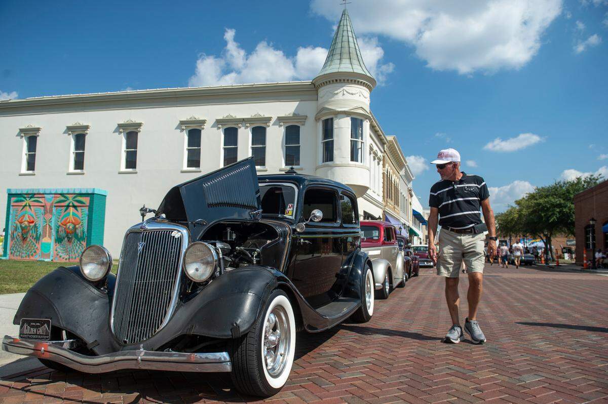 Spectators walk down Howard Avenue during the Biloxi Block Party, a Cruisin’ The Coast event in Biloxi on Wednesday, Oct. 9, 2024.