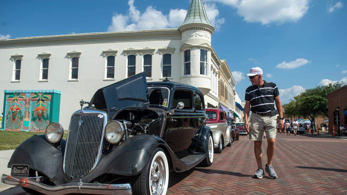 Spectators walk down Howard Avenue during the Biloxi Block Party, a Cruisin’ The Coast event in Biloxi on Wednesday, Oct. 9, 2024.