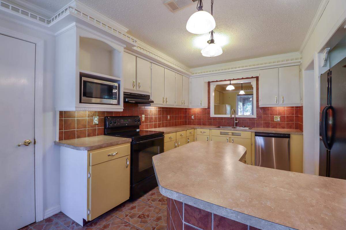 The kltchen of this home listed in the Bayou View subdivision of Gulfport has a new dishwasher and updated light covers.