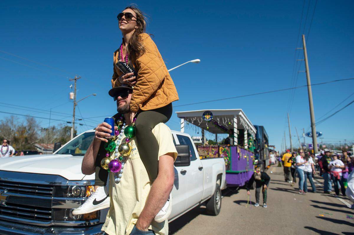 Revelers take photos with floats during the Krewe of Nereids Mardi Gras parade on Highway 90 in Bay St. Louis on Sunday, Feb. 12, 2023.