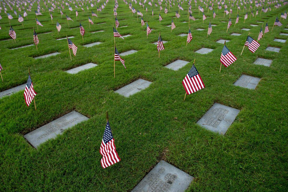 Thousands of tiny American flags decorate the graves of American service members at Biloxi National Cemetery in Biloxi ahead of Memorial Day on Saturday, May 25, 2024.