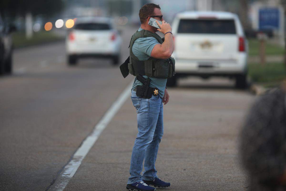 A member of law enforcement assesses the scene where two Bay St. Louis police officers were shot and killed at Motel 6 on Highway 90 on Wednesday, Dec. 14, 2022.