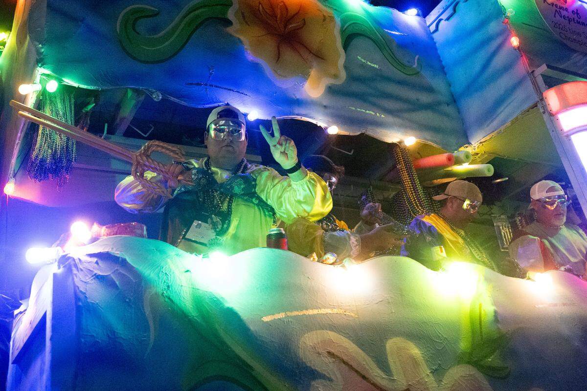Parade participants ride their floats down Howard Avenue during the Krewe of Neptune parade in Biloxi on Saturday, Feb. 14, 2026.