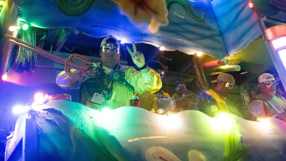 Parade participants ride their floats down Howard Avenue during the Krewe of Neptune parade in Biloxi on Saturday, Feb. 14, 2026.