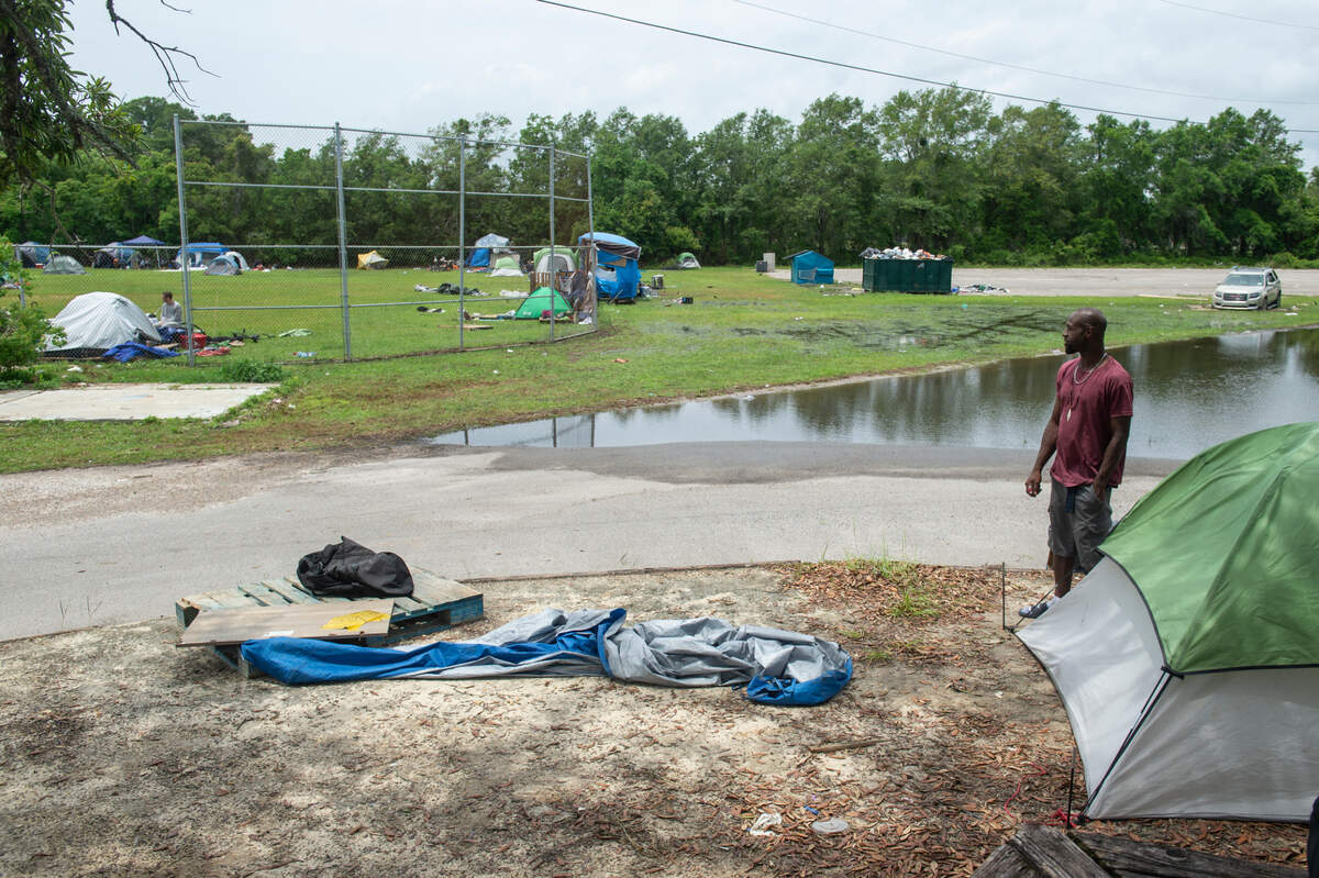 Tents temporarily house people experiencing homelessness at the former Mercy Cross High School in Biloxi on Tuesday, May 14, 2024. Those staying on the property were asked to move from the woods to open spaces while Catholic Social Services of South Mississippi refurbishes the property for a new day center set to open May 28.