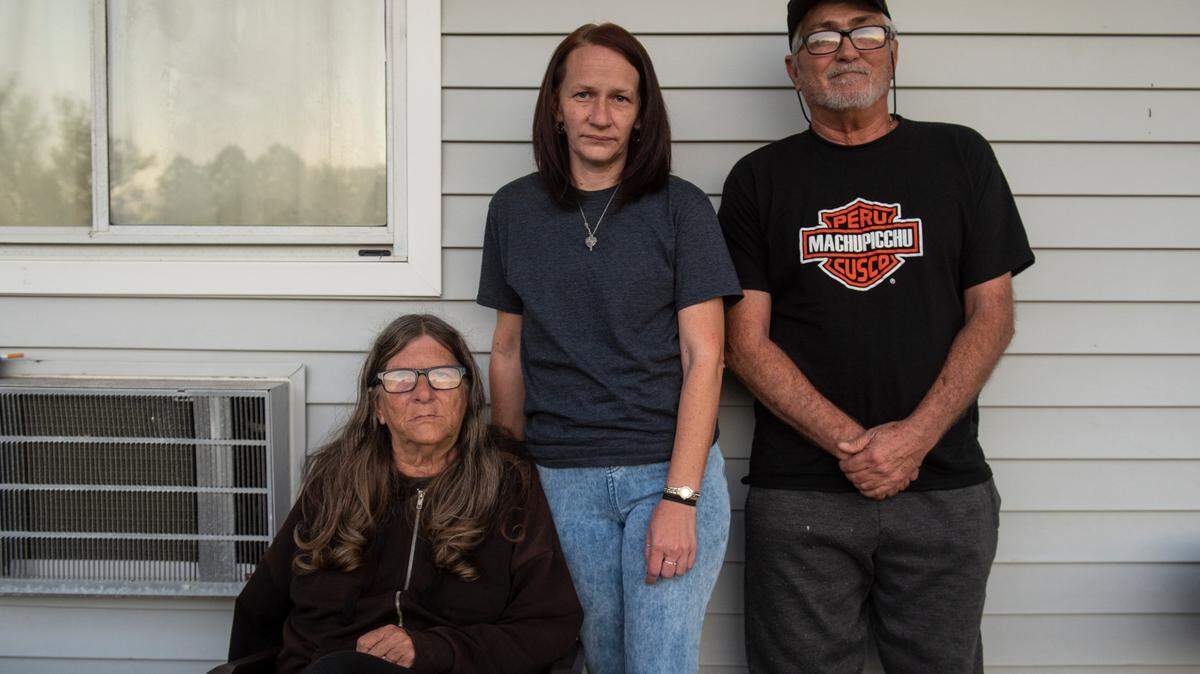 John Hunter, right, his fiancé Lisa Walker, left, and Lisa’s daughter pose for a portrait on Friday, Jan. 6, 2023 outside the room at the Motel 6 they were renting when Amy Brogdon Anderson shot and killed Sgt. Steven Robin and Branden Estorffe in the motel’s parking lot. The family witnessed the shooting and have been dealing with the emotional aftermath.