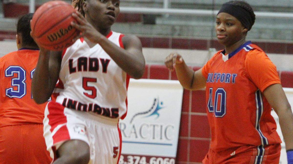 JOHN FITZHUGH/SUN HERALD 
 Biloxi's Tytiana Broomfield drives to the basket after beating Gulfport's Jatiah Lathan during the first period of their game at Biloxi on Friday Jan. 22, 2015.