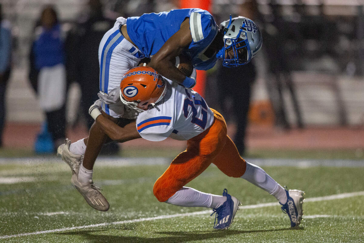 Ocean Springs’ Christian White gets tackled by Gulfport during a game at Greyhound Stadium in Ocean Springs on Friday, Oct. 28, 2022.