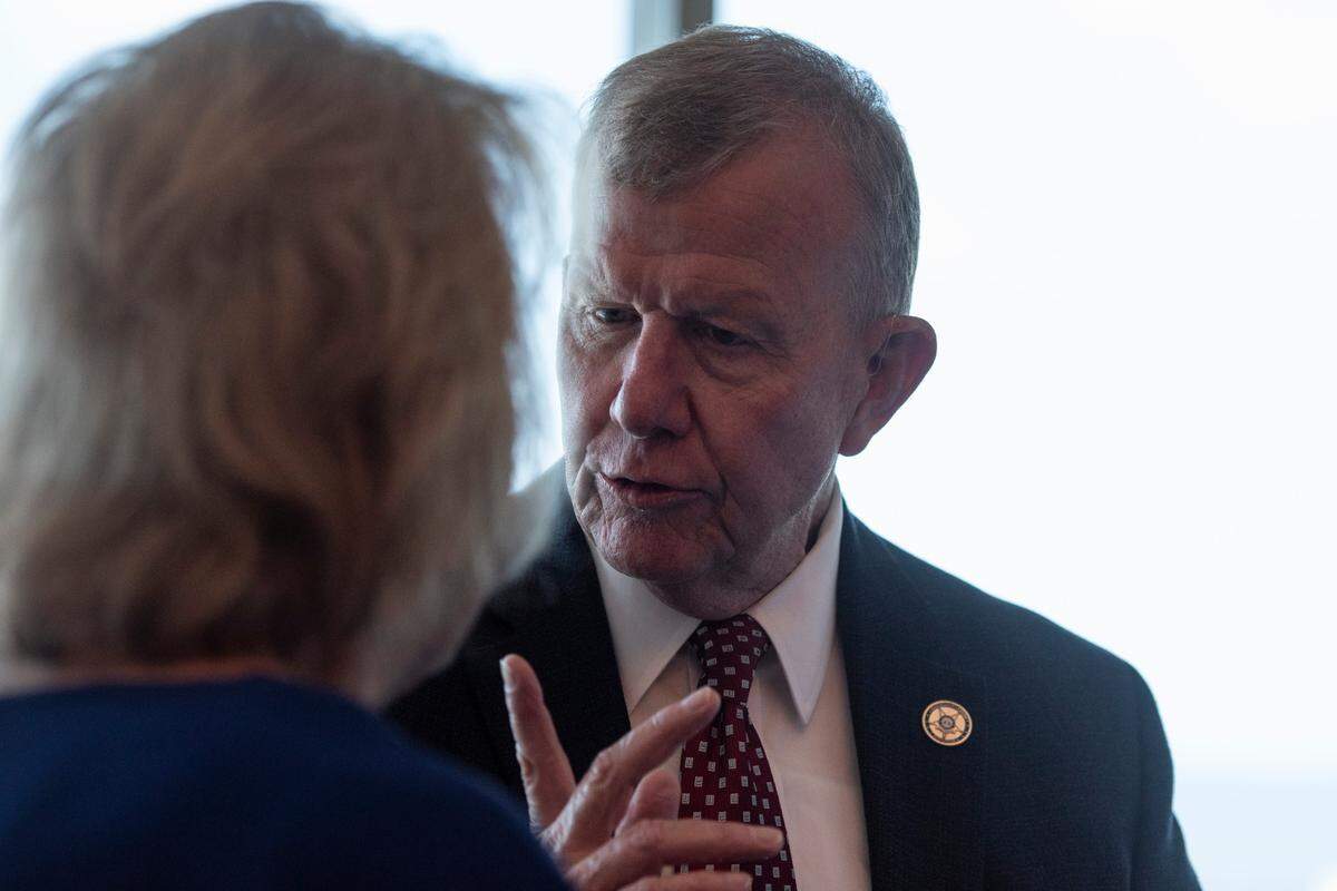 Jackson County Sheriff Mike Ezell, who is running for Congress, talks to a supporter during an Ezell campaign press conference at the Great Southern Club in Gulfport on Thursday, June 9, 2022.
