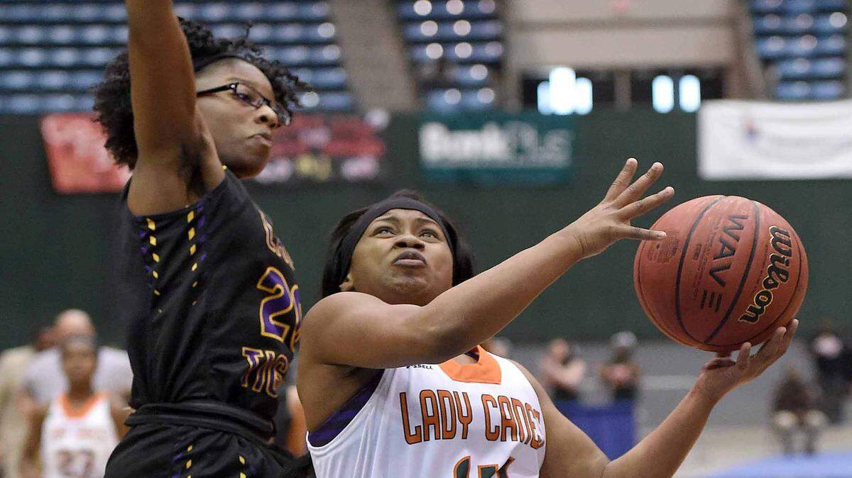 CHRIS TODD/SPECIAL TO THE SUN HERALD 
 West Harrison's Gerriana Williams (14) takes the ball to the basket against Hattiesburg's Curtia Giles (20) on Tuesday, March 8, 2016, in the MHSAA State Basketball Tournament semifinals at the Mississippi Coliseum in Jackson, Miss.