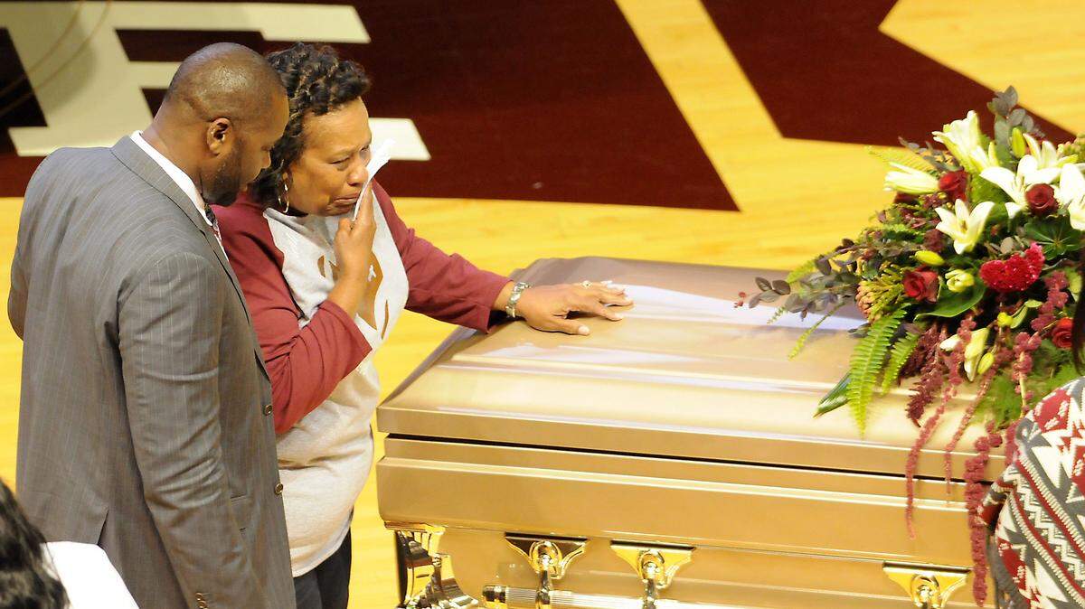 JIM LYTLE/ASSOCIATED PRESS 
 A family member weeps next to the casket of Keith Joseph Sr., following his memorial service at Mississippi State University on Thursday in Starkville. Mississippi State hosted a memorial service in honor of a father and son who both played for the Bulldogs and were killed in a car accident on Friday.