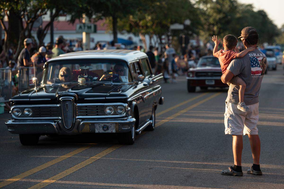Spectators wave to the Cruisers during the Long Beach Parade in Long Beach, one of the events in Cruisin’ The Coast, on Monday, Oct. 7, 2024.
