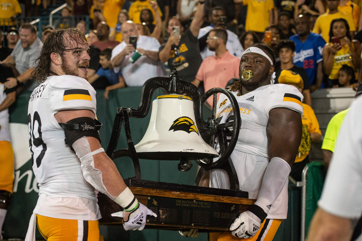 Southern Miss carry the bell shortly before it was broken after winning the Battle of the Bell against Tulane at Yulman Stadium in New Orleans on Saturday, Sept. 24, 2022.