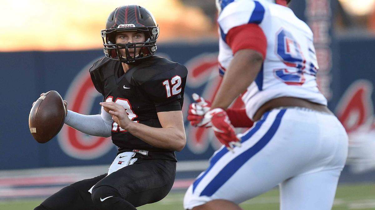 St. Stanislaus quarterback Myles Brennan (12) looks to avoid the sack by Noxubee's Jeffrey Simmons (94) on Saturday, December 5, 2015, in the MHSAA Class 4A State Football Championship in Vaught-Hemingway Stadium on the Ole Miss campus in Oxford.
