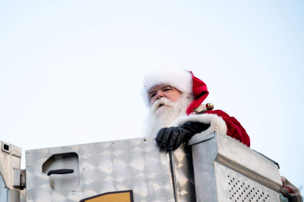 Santa Claus looks out to the crowd from the top of a firetruck during the Champions Christmas Parade in Gulfport on Monday, Dec. 8, 2025.