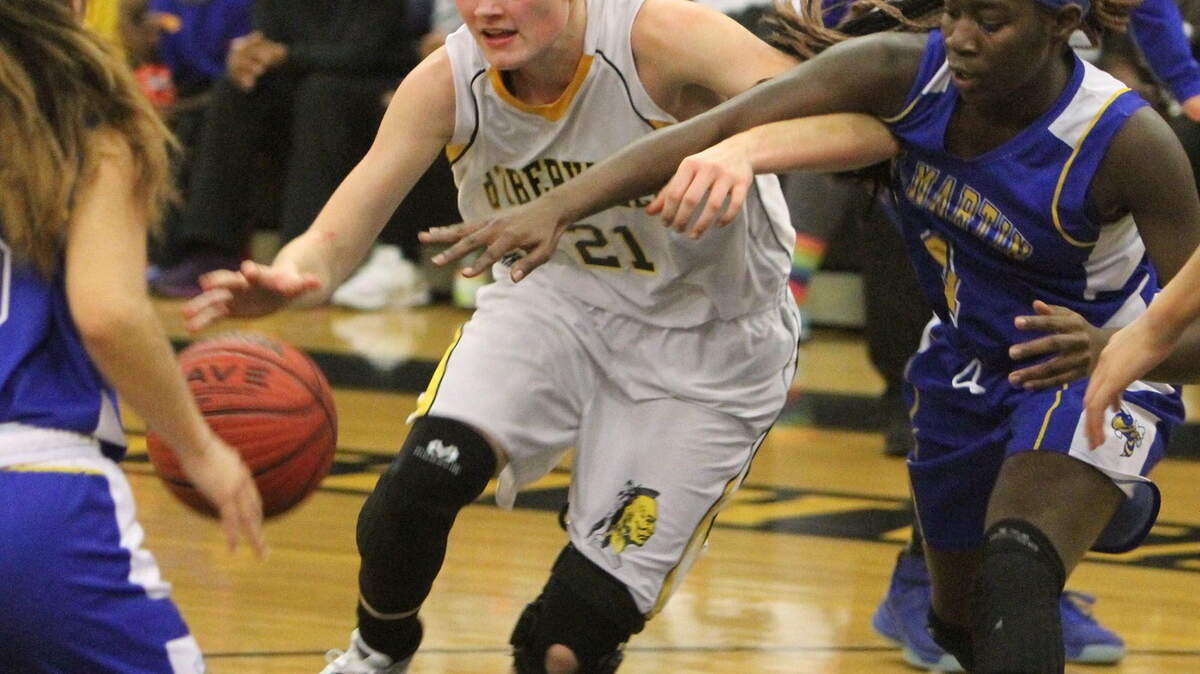 JOHN FITZHUGH/SUN HERALD 
 D'Iberville's Casey Fountain is fouled by St. Martin's Mercedes Brown during the second quarter of their game at D'Iberville on Friday Jan. 8, 2016.