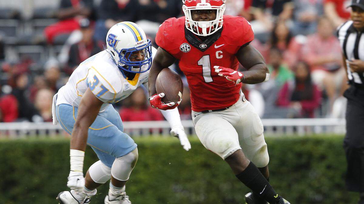 Georgia running back Sony Michel (1) breaks away from Southern running back Dakota Starks (37) in the second half of an NCAA college football game Saturday, Sept. 26, 2015, in Athens , Ga. (AP Photo/John Bazemore)