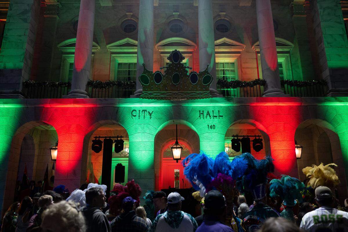A crowd gathers as they wait to see the lights of Biloxi City Hall change during a 12th Night Celebration in Biloxi on Monday, Jan. 5, 2026.
