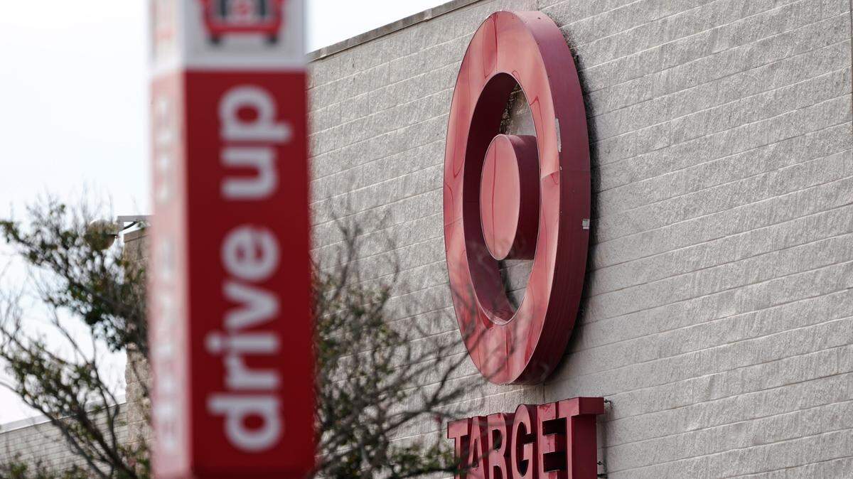 A sign designating a drive up parking lot for curbside pickup stands out against the backdrop of the Target logo outside this northeast Jackson, Mississippi, store. The retail giant announced plans to test new curbside pickup options, including Starbucks coffee orders and returns, in select markets in fall 2022. (AP Photo/Rogelio V. Solis)