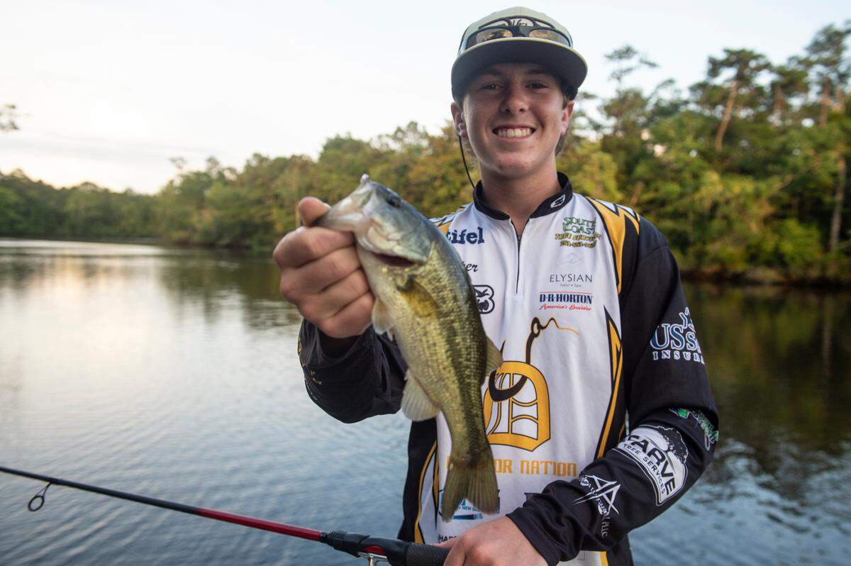 D’Iberville Bass Fishing Team member Cooper Rouse holds out a fish he caught while fishing on the Tchoutacabouffa River in D’Iberville on Monday, June 3, 2024.