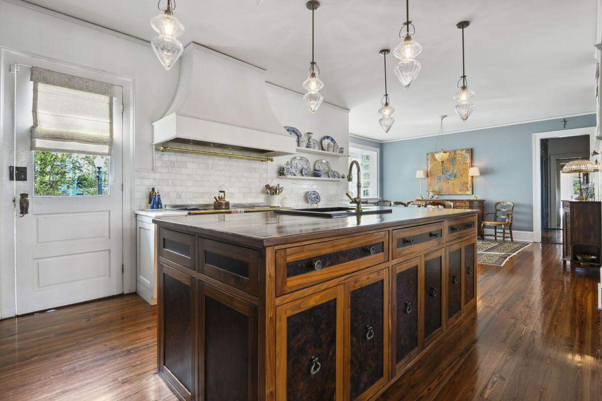 The kitchen in this Pass Christian mansion has been redone to include double dishwashers, double ovens, a sub zero refrigerator and wine cooler, an icemaker, a walnut custom wood island, hand built cabinets and marble counters.