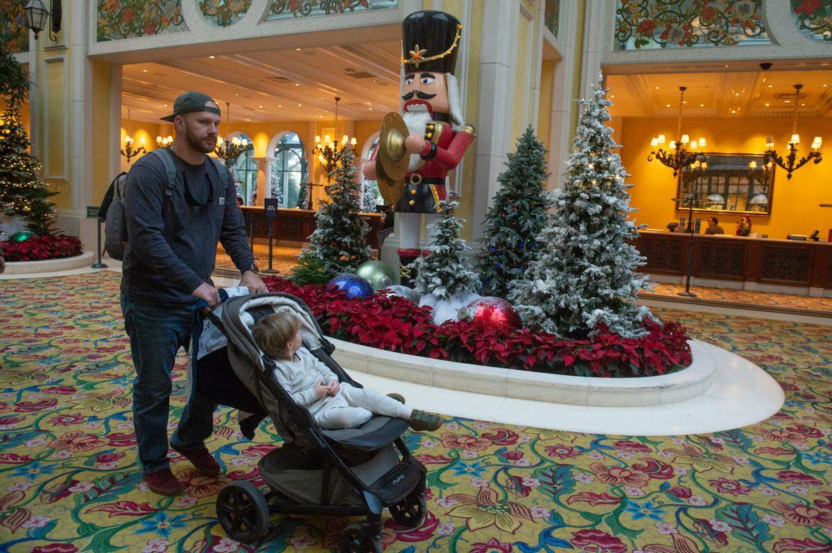 Corey Brown and Jasper Brown, of Albany, GA, walk past Christmas displays in the lobby at the Beau Rivage Casino in Biloxi on Thursday, Dec. 1, 2022. The Beau Rivage, which decorates every year for Christmas, is one of the few Coast casinos to allow children.