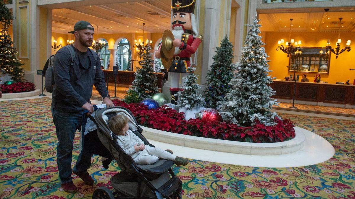 Corey Brown and Jasper Brown, of Albany, GA, walk past Christmas displays in the lobby at the Beau Rivage Casino in Biloxi on Thursday, Dec. 1, 2022. The Beau Rivage, which decorates every year for Christmas, is one of the few Coast casinos to allow children.