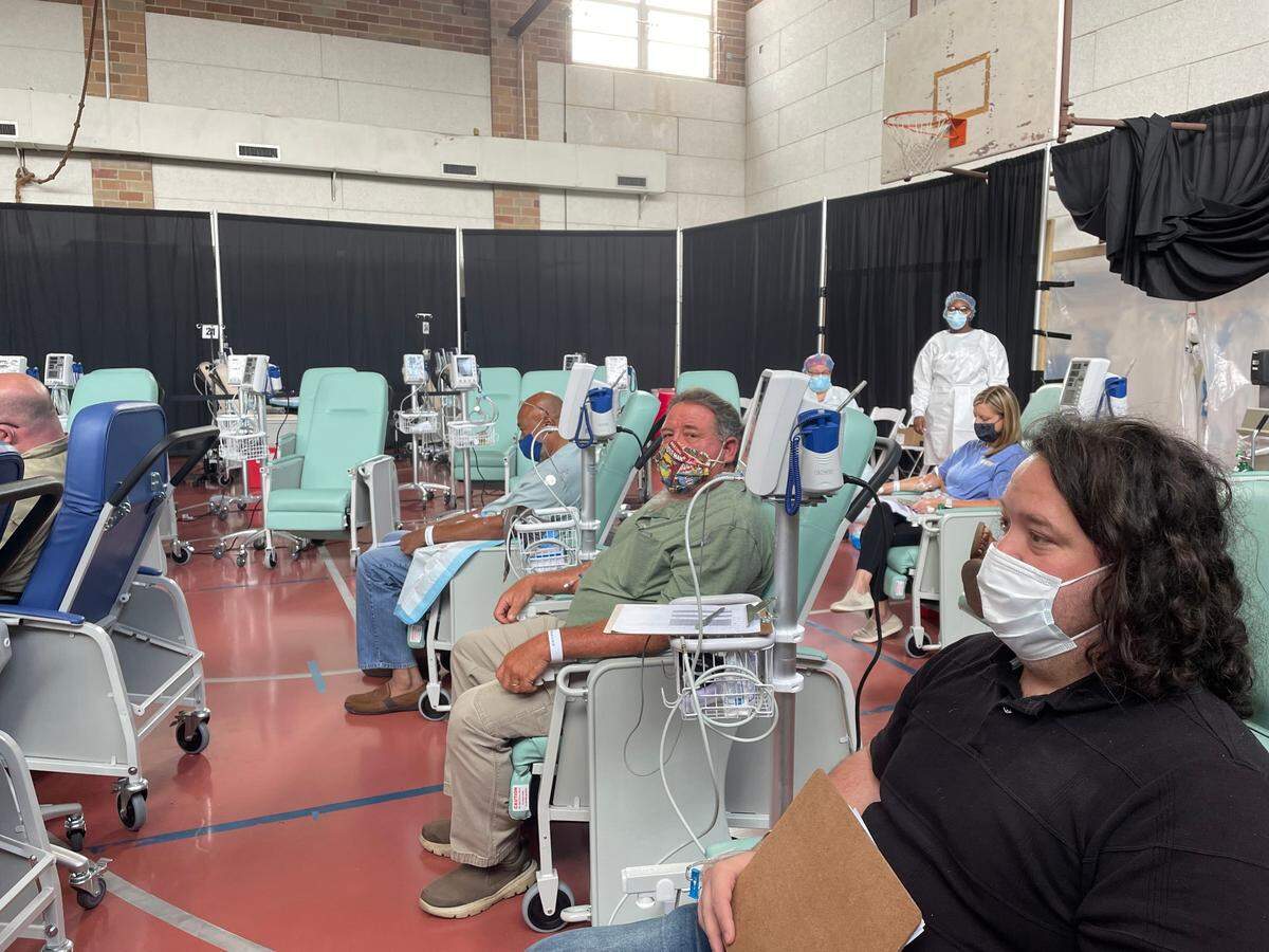 Bay St. Louis resident Dwayne Turner, 37, Long Beach resident Henry Schepens, 59, and Gulfport resident James Kirksey, 60, wait for an hour while monitored by nurses following their monoclonal infusion treatments.