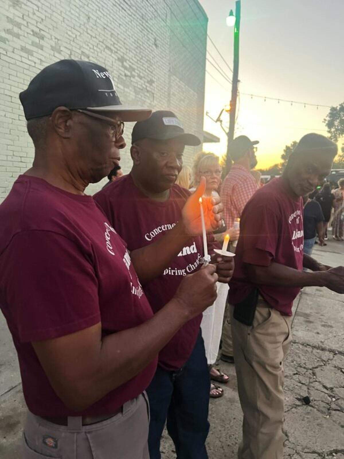 People participate in a candlelight vigil Monday in Leland to honor victims of gunfire that occurred days earlier during a homecoming block party.
