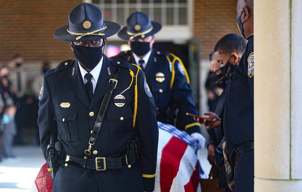 Harrison County Honor Guard escorts the casket of fallen Hancock County Deputy Lt. Michael Boutte outside of the Bay St. Louis Community Hall for law enforcement honors Tuesday, February 9, 2021.