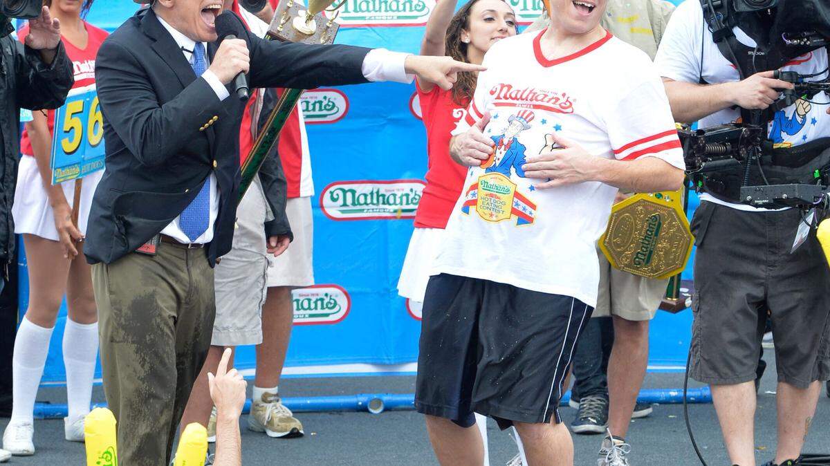COURTESY/SHEA COMMUNICATIONSJoey 'Jaws' Chestnut, center, wins the 2014 Nathan's Hot Dog Eating Contest.