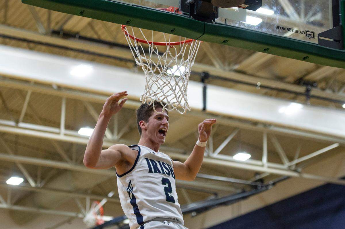 St. Patrick guard Nick Krass cheers as he makes a dunk during a game against Perry Central at St. Patrick Catholic High School on Thursday, Jan. 13, 2022.