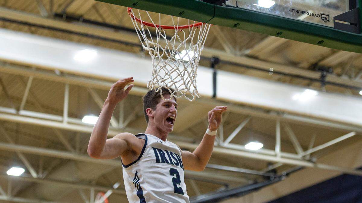 St. Patrick guard Nick Krass cheers as he makes a dunk during a game against Perry Central at St. Patrick Catholic High School on Thursday, Jan. 13, 2022.
