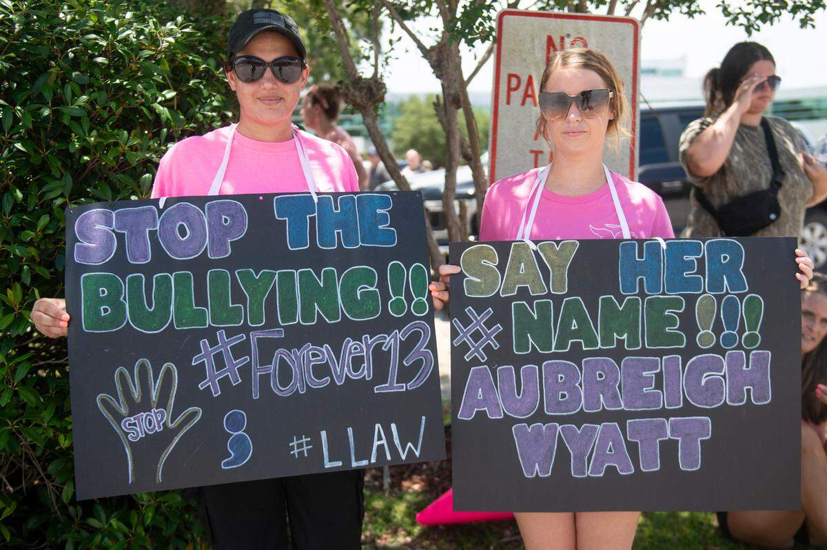 Chasedy Ferrer, of Hurley, and Wynonna Harris, of Vancleave, hold signs in support of Aubreigh Wyatt outside the Jackson County Courthouse in Pascagoula on Thursday, July 18, 2024.