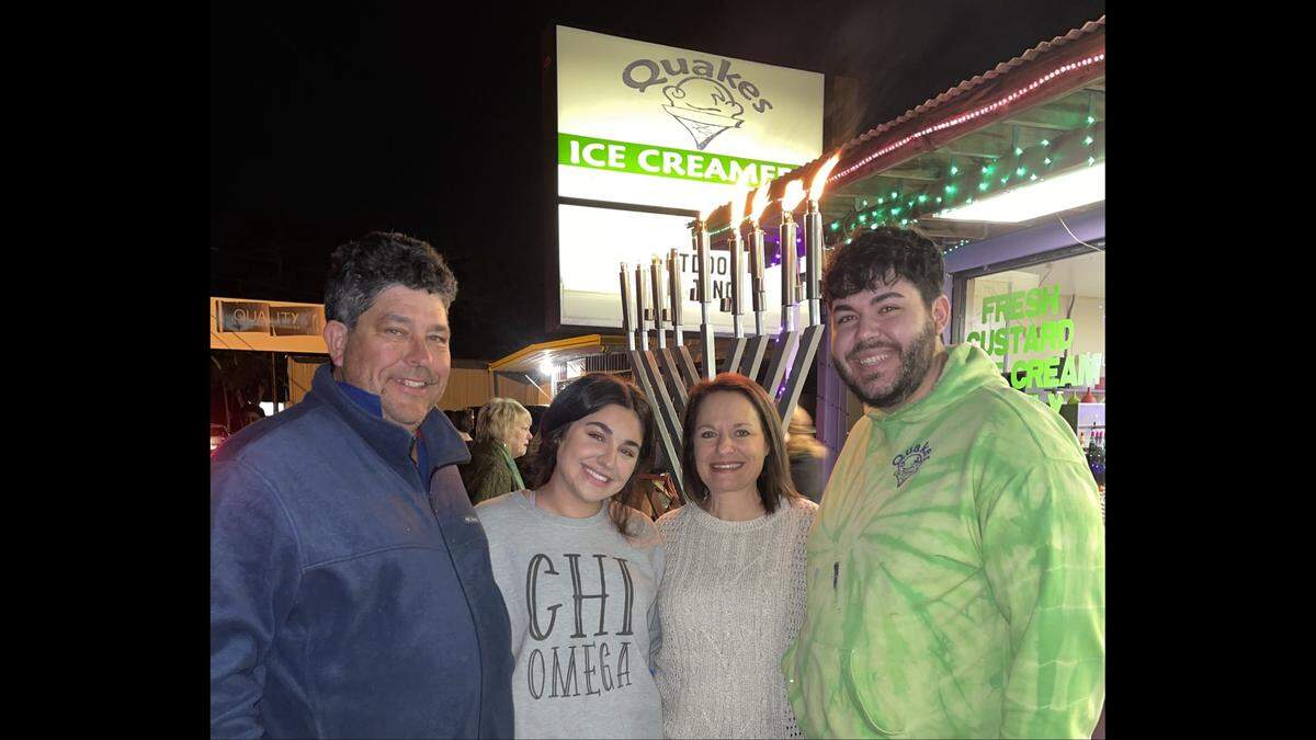 Marie Garbin, second from right with her husband, Paul, and children Nick and Julia, light the menorah every year during the holidays in memory of her father.