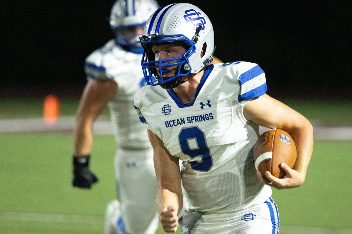 Ocean Springs quarterback Chalmers Berglind (9) picks up some yards Friday in the Greyhounds’ 56-42 victory at Picayune.