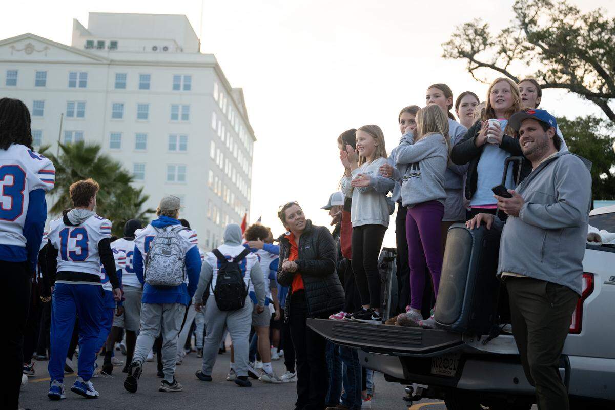 Parade attendees cheer as Gulfport players walk during the Champions Christmas Parade in Gulfport on Monday, Dec. 8, 2025.