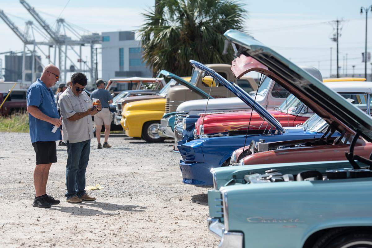 Spectators look at classic cars during View the Cruise, one of the first events of Cruisin’ The Coast, in Gulfport on Sunday, Oct. 6, 2024.