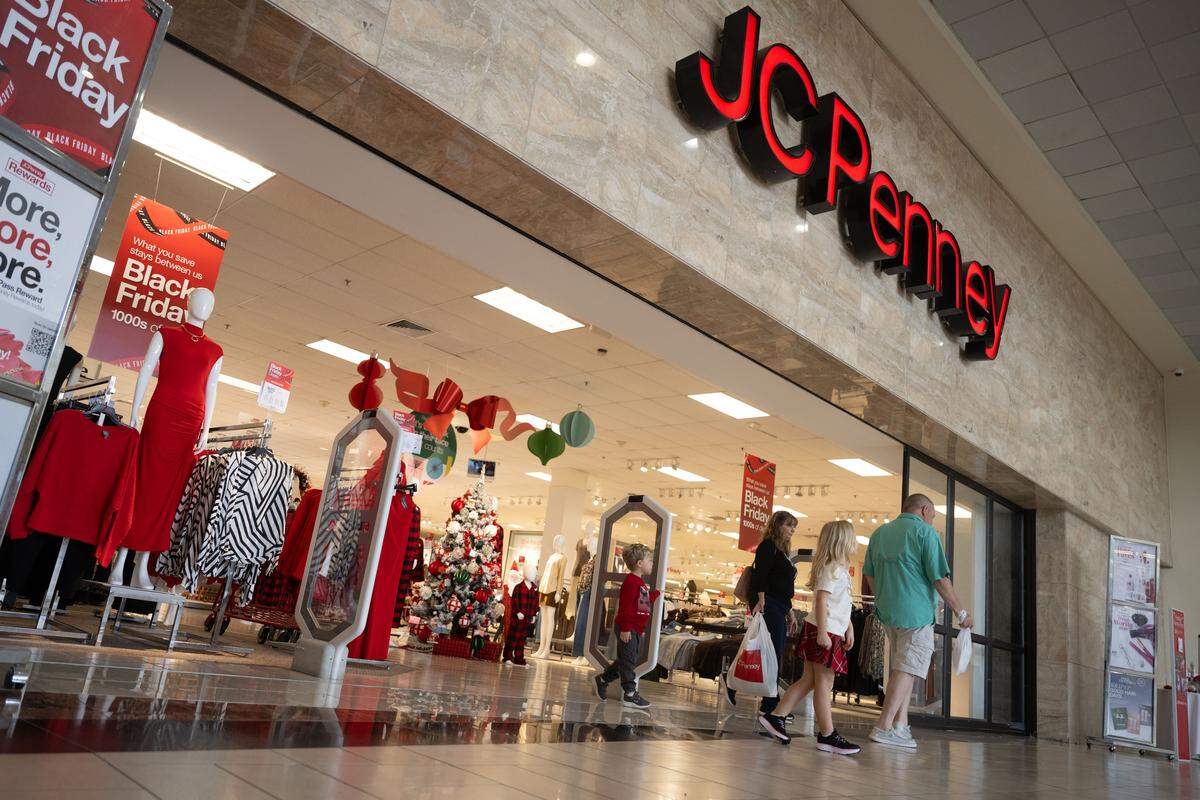 People shop throughout Edgewater Mall in Biloxi, looking for deals to stretch their holiday budgets.